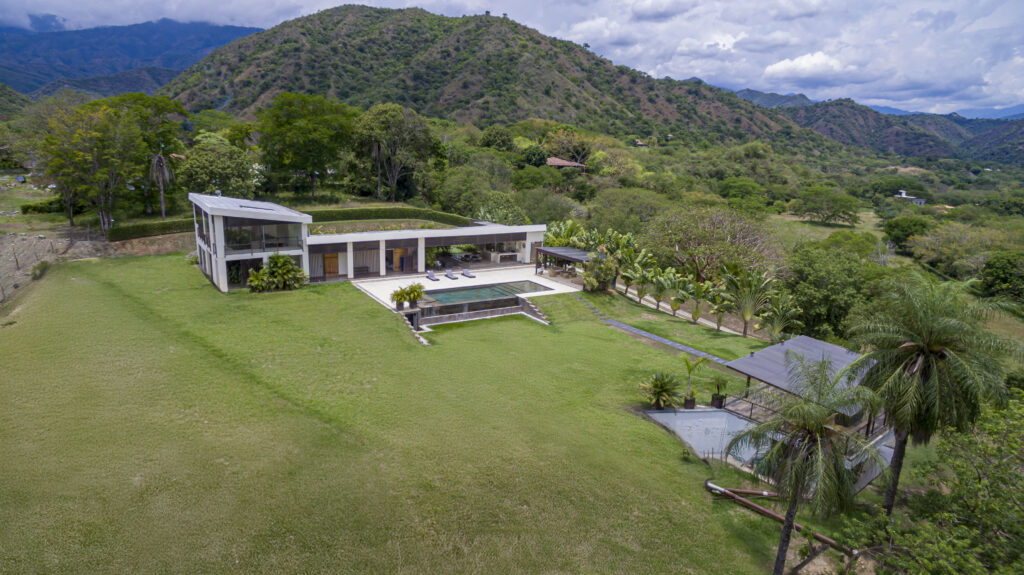 Aerial view of Finca Río Adentro country house with pool surrounded by mountains near Medellín